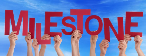 People Hands Holding Red Word Milestone Blue Sky — Stock Photo, Image