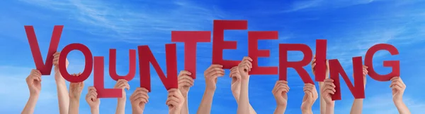 Many People Red Word Volunteering Blue Sky — Stock Photo, Image