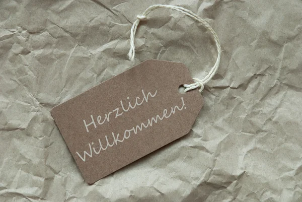 Etiqueta Beige Herzlich Willkommen significa Bienvenido — Foto de Stock