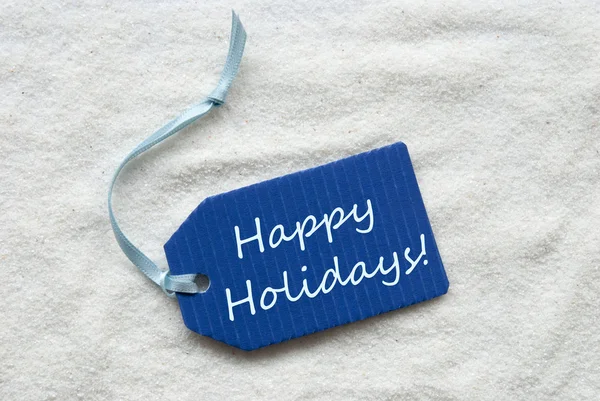 Joyeuses fêtes sur fond de sable étiquette bleue — Photo