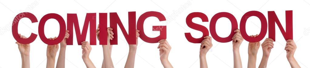 Many Caucasian People And Hands Holding Red Straight Letters Or Characters Building The Isolated English Word Coming Soon On White Background