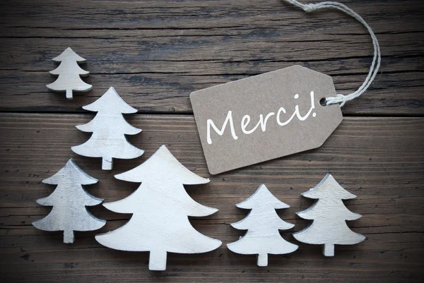 Etikett und Weihnachtsbäume merci bedeutet Danke — Stockfoto