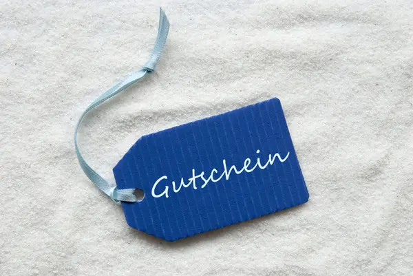 Gutschein Means Voucher On Blue Label Sand — Stock Photo, Image