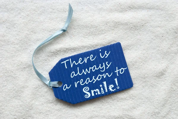 Always Reason To Smile On Blue Label Sand Background — Stock Photo, Image
