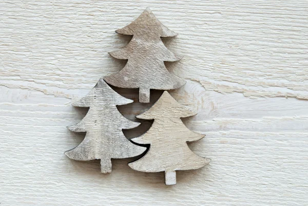 Three Christmas Trees On White Wooden Background — Zdjęcie stockowe