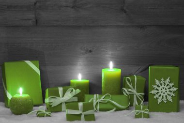 Christmas Decoration With Green Candles, Presents And Snow