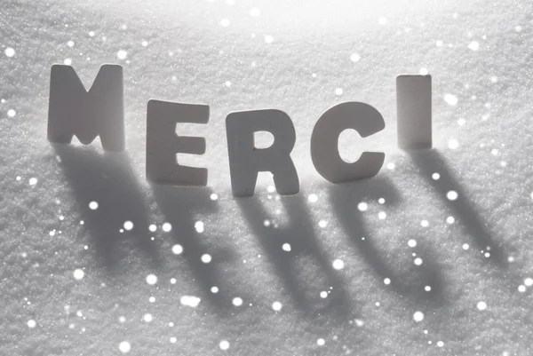 White Word Merci Means Thank You On Snow, Snowflakes — стокове фото