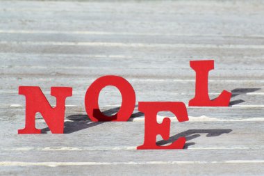 Card With Red Letters Noel Means Christmas On White Wood