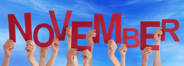 Many People Hands Holding Red Word November Blue Sky — Stock Photo, Image