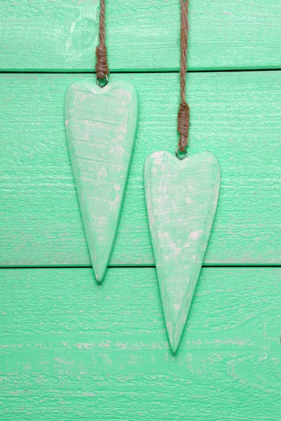 Dois corações com espaço de cópia, fundo de madeira verde, imagem vertical — Fotografia de Stock