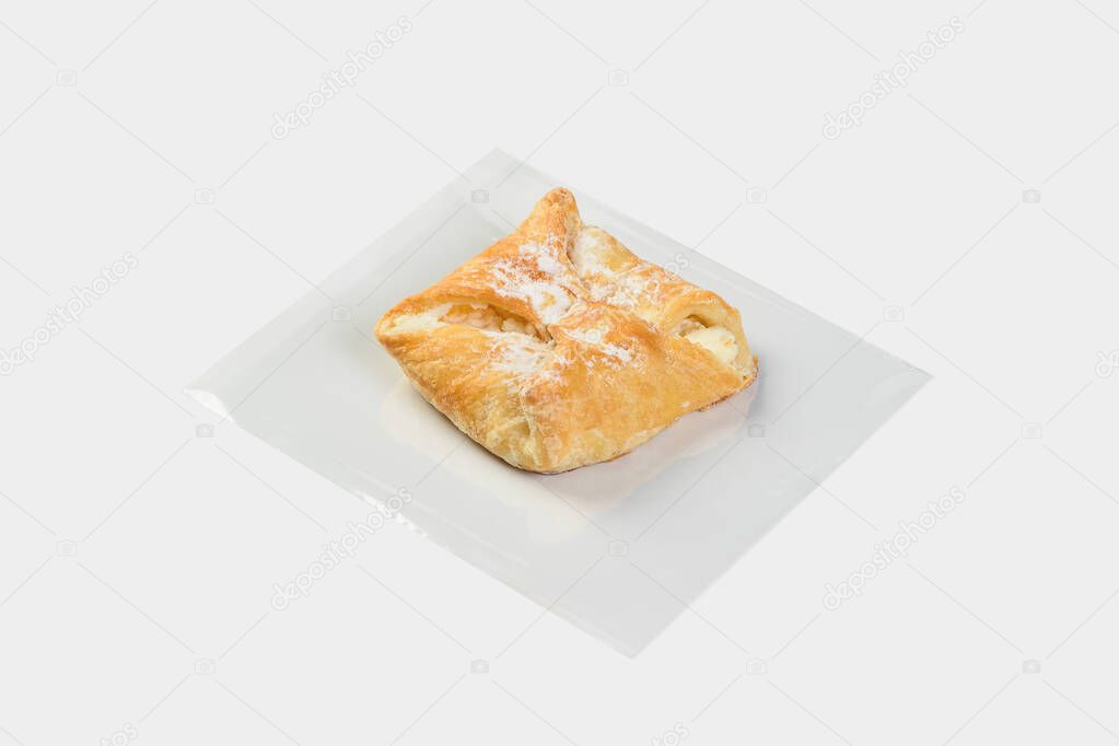 sweet puff pastry bun with filling, sprinkled with powdered sugar