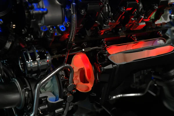 the internal combustion engine of a car in a section to demonstrate the internal parts. A mock-up of the engine at the exhibition.