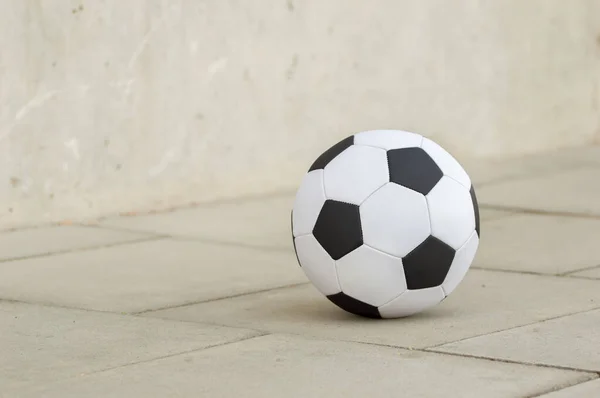 Cropped image of a soccer ball in the street