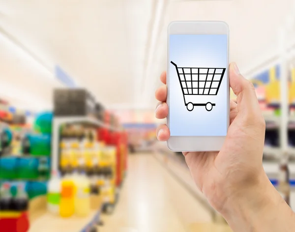 Smartphone in supermarket — Stock Photo, Image