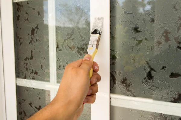 Painting the window with brush — Stock Photo, Image