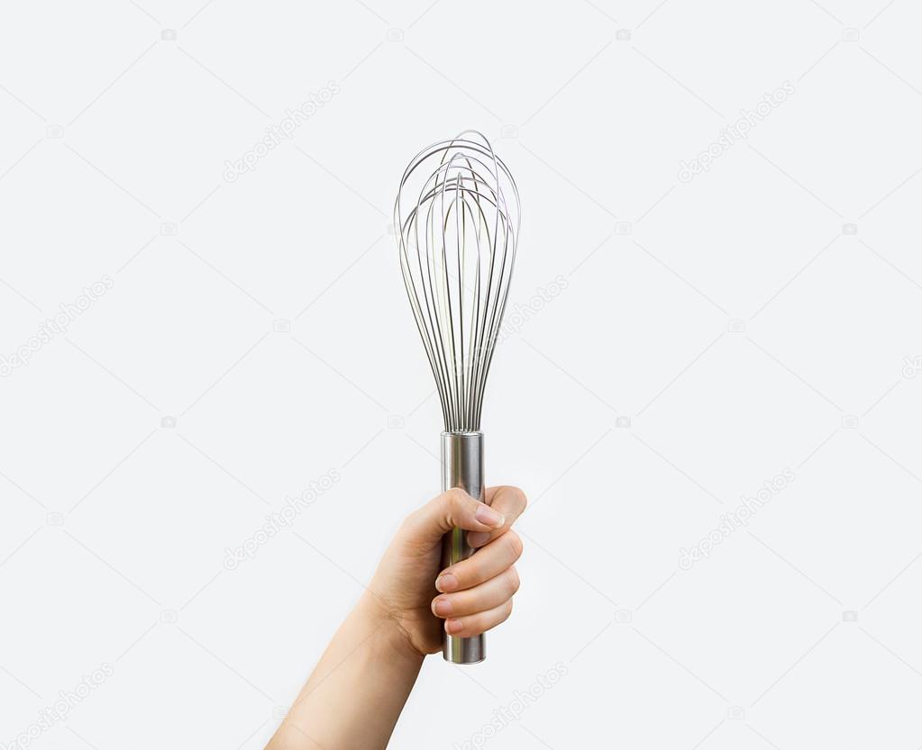 hand holding a whisk 