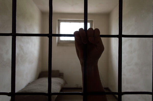 hand of prisoner into the cell