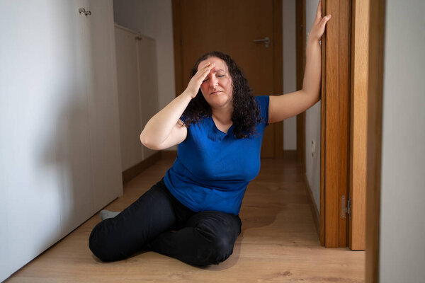 Front view portrait of a dizzy woman feeling sick at home