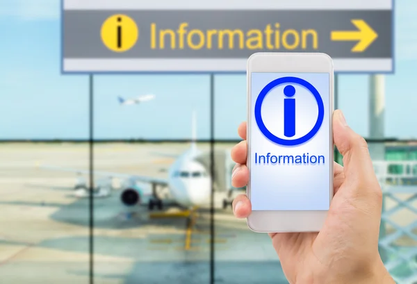 Information with smartphone at the airport — Stock Photo, Image