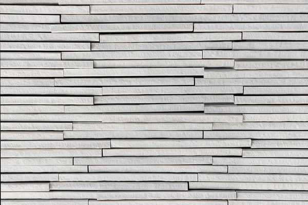 Vit sten plattor lager grov texturerat bakgrund — Stockfoto