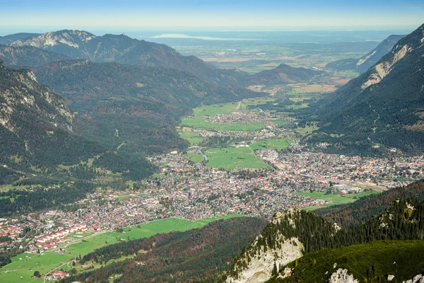 Green valley with small town in Alps mountains — Stock Photo, Image