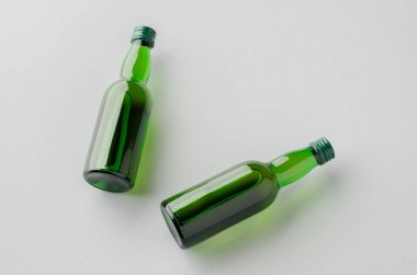Miniature spirits, liquor bottle mockup, green glass.
