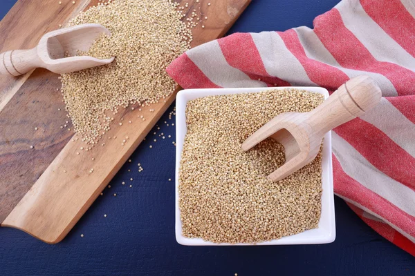 White grain quinoa on blue wood background. — Stok fotoğraf