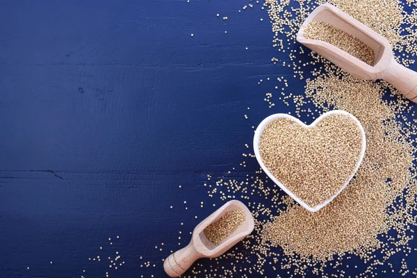 White grain quinoa on blue wood background. — Stok fotoğraf