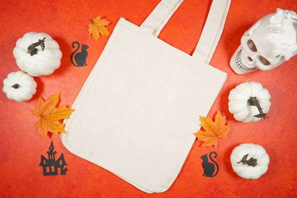 Halloween trick or treat product mockup with white skull and pumpkins. — Stock Photo, Image