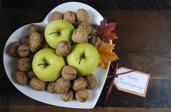 Ημέρα των ευχαριστιών Harest μήλα και καρύδια, στο πιάτο σχήμα καρδιά — Φωτογραφία Αρχείου