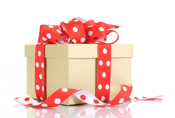 Festive holiday Kraft paper gift box with red polka dot ribbon — Stock Photo, Image