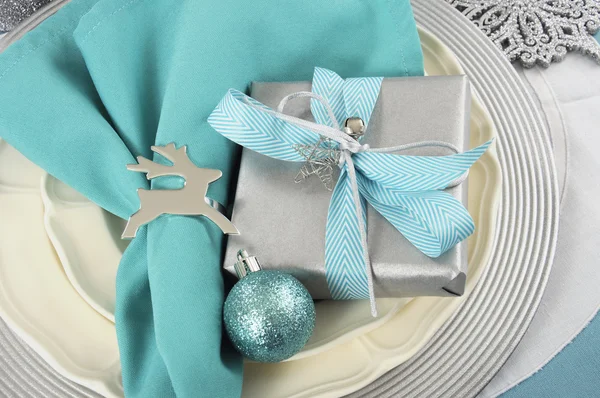 Modern Christmas table place settings in aqua blue, silver and white theme. Closeup. Stock Picture