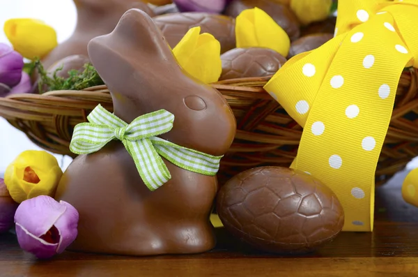 Happy Easter chocolate bunnies and eggs in hamper basket. — Stock Photo, Image