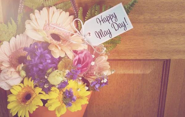 Happy May Day gift of flowers on door. — Stock Photo, Image