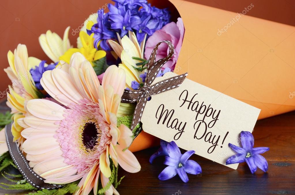 Happy May Day traditional gift of Spring Flowers. Stock Photo by