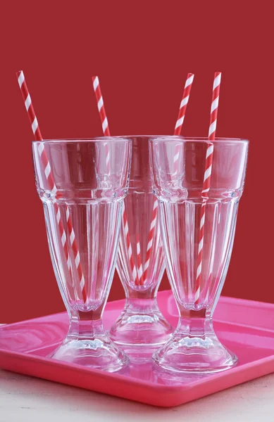 Empty soda pop glasses with straws. — Stock Photo, Image