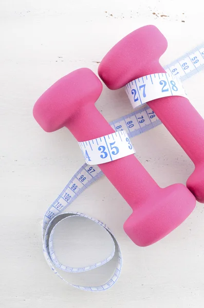 Health and fitness concept with feminine dumbbells — Stock Photo, Image