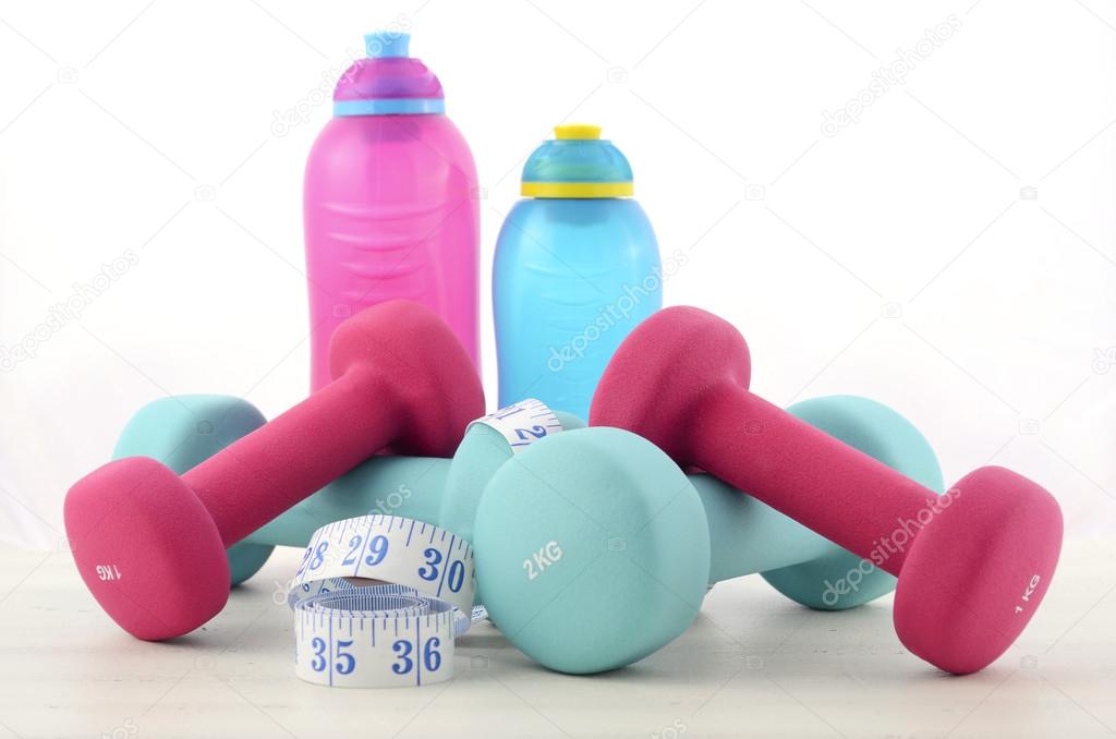 Health and fitness concept with feminine dumbbells