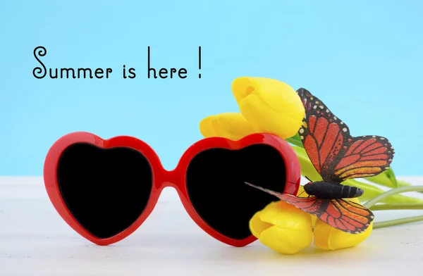 Summer Is Here concept with red heart shape sunglasses — Stock Photo, Image