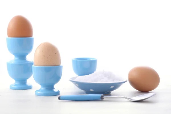 Eggs in blue egg cups. — Stock Photo, Image