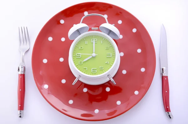 Mealtime table place setting with alarm clock — Stock Photo, Image