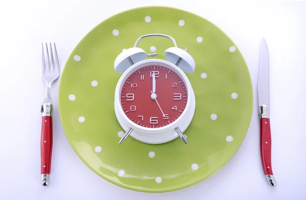 Mealtime table place setting with alarm clock — Stock Photo, Image