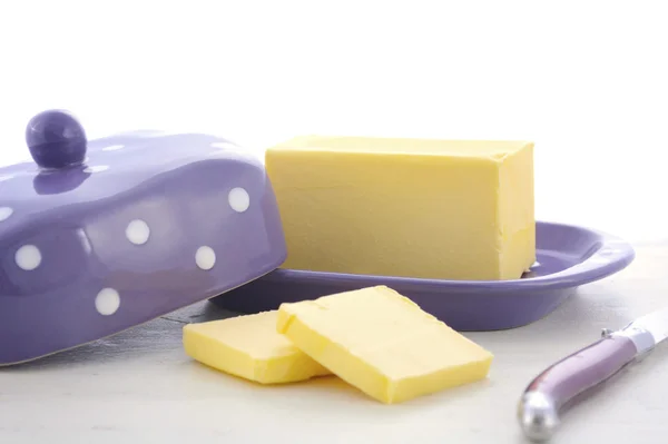 Butter on white wood table. — Stock Photo, Image