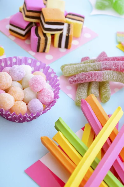 Bright Colorful Candy on Pale Bluw Wood Table. — 图库照片