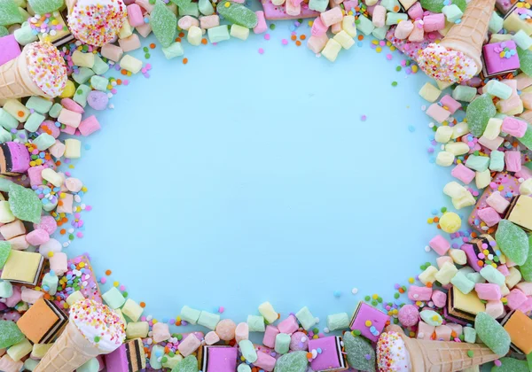 Bright colorful candy on pale blue wood table. — Stok fotoğraf