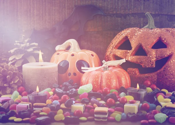 Halloween Candy with pumpkins on dark wood background. — Stock Photo, Image