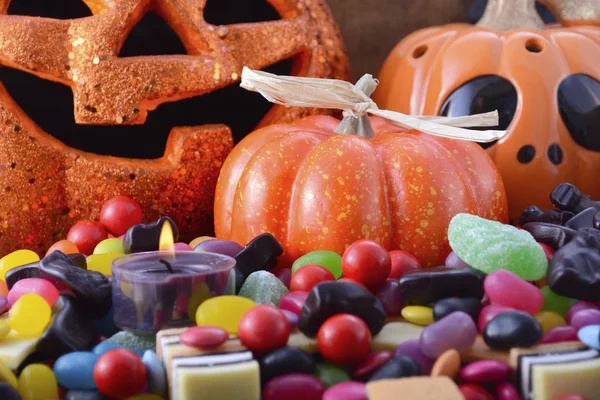 Halloween Candy with pumpkins on dark wood background. — Stock Photo, Image