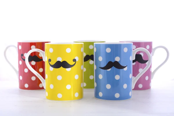 Colorful coffee mugs with mustaches. — Stockfoto