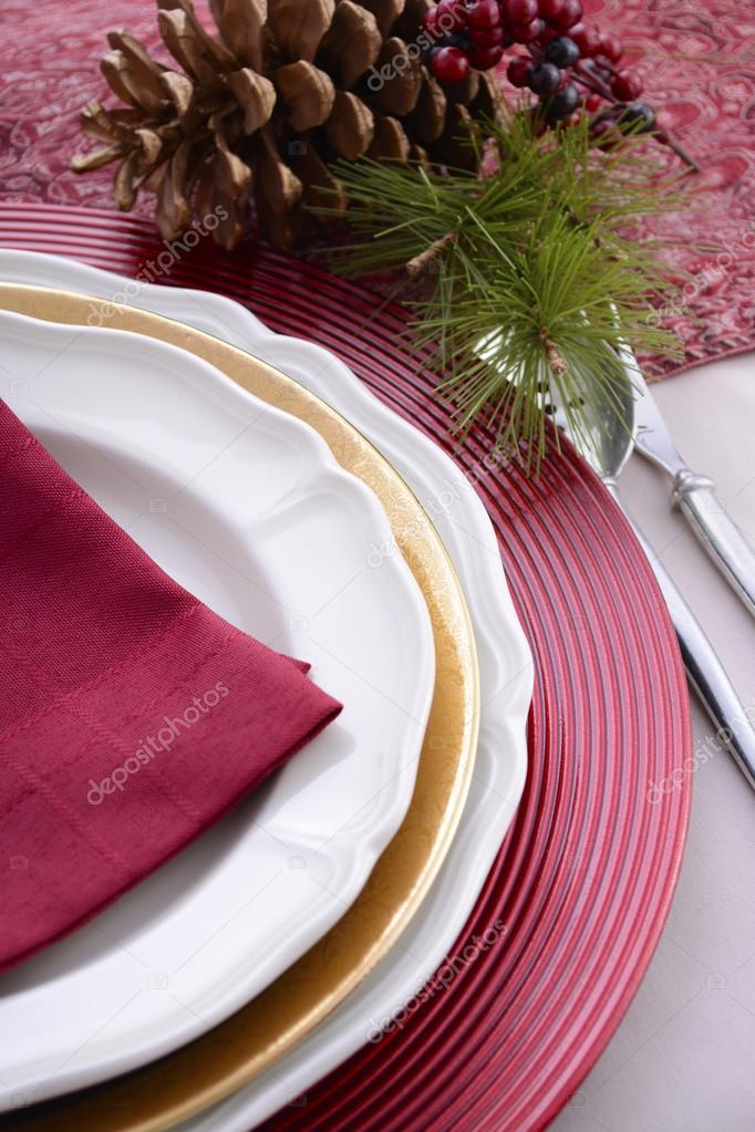Traditional red theme festive table place setting.