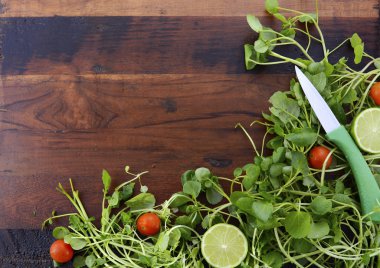Salad Preparation with Watercess on Wooden Table.
